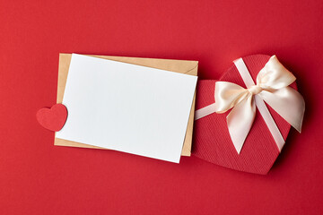 Valentines day card mockup with envelope and heart gift box on red paper background