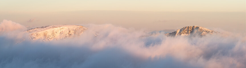 Peaks emerge from the clouds at sunset