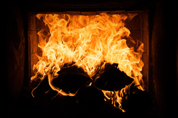 Burning cozy fire. Glowing fireplace logs. Coziness warm christmas time.