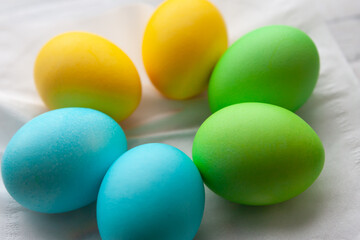 Close-up. Painted Easter eggs on light wooden background, top view