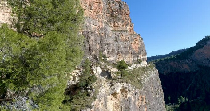 Senda alta monta&ntilde;a suspendida en gran pared vertical de piedra y dron volando