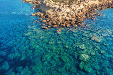 Aerial view of yellow stone island coast with azure and blue tropical sea water, summer travel concept, beautiful nature landscape.