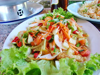 Thai spicy salad Somtam...The main ingredient is green papaya.