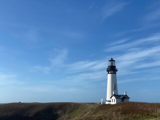 lighthouse on the coast with a field  © Sam