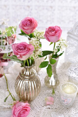 beautiful arrangement with single pink roses in silver vases