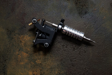 tattoo machine, tattoo gun on rusty metal background