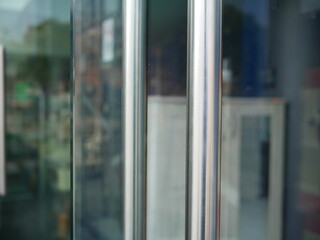 closeup of metal handle door with glass door in office.