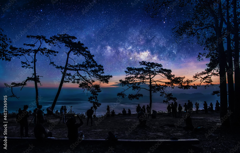 Wall mural tourist with milky way galaxy on the mountain viewed from a high angle. image exposure with long gra