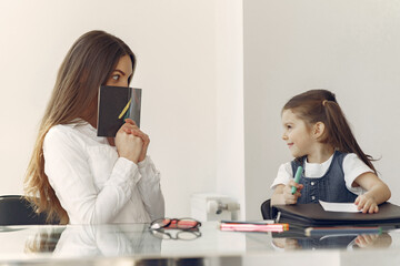 Tutor with pupil. Little girl studying. Private lesson.