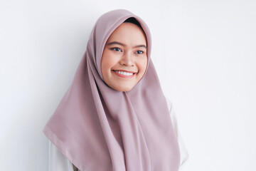 Young Asian Islam woman wearing headscarf with smile in face to camera. Indonesian woman. Beauty concept isolated on gray background