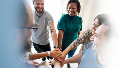 Diverse people stacking their hands in the middle