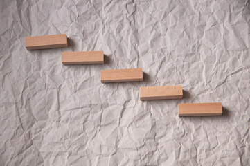 background of crumpled craft paper with wooden rectangles arranged in a certain order