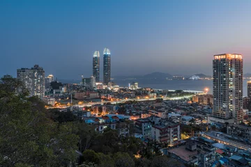 Fotobehang Xiamen city skyline with modern buildings, old town and sea at dusk © Sen