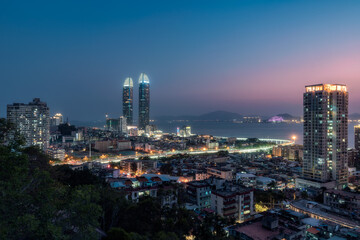 Fototapeta na wymiar Xiamen city skyline with modern buildings, old town and sea at dusk