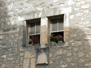 Window with flowers and sundial