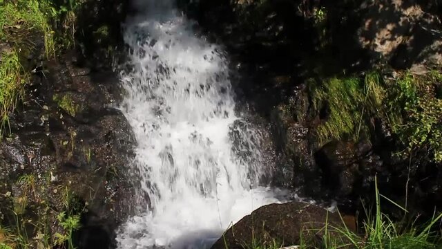 Running water of a small beautiful waterfall, Vang, Norway.