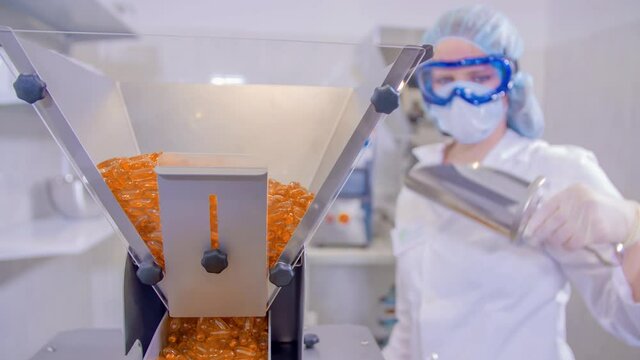 Pharmacy medicine capsule pill being pout and fill into the machine by an operator.