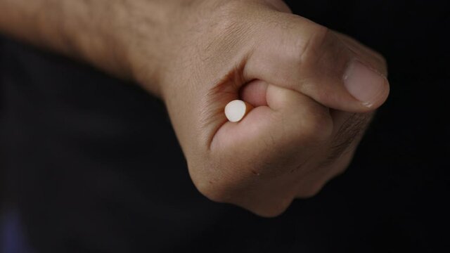 A young man crushed cigarettes with his hand. Because he wants to quit smoking. World No Tobacco Day.
