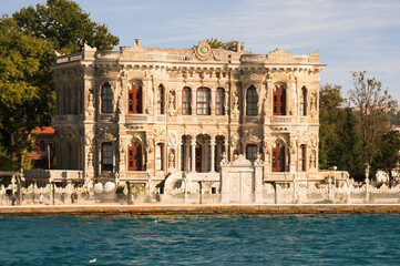 Fototapeta na wymiar View from the waters of Bosporus Strait on Kucuksu Palace, a historic Neo-Baroque waterfront palace built as a summer residence for Ottoman sultans in Beykoz district of Istanbul