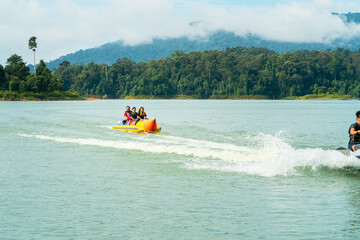 Fototapeta premium People enjoying water activities on banana boat at the Kenyir Lake, Terengganu, Malaysia.