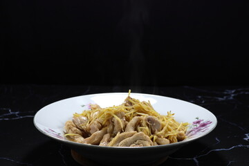 Classic fried shredded fresh ginger with cutting chicken meat serving on the plate. Famous spicy appetizer menu in Asian restaurant. 