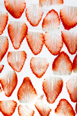 Thinly sliced ​​strawberries on white background. © Yuliia