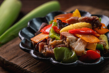 Delicious homemade stir-fried salted pork with colorful vegetablesbaby corn.