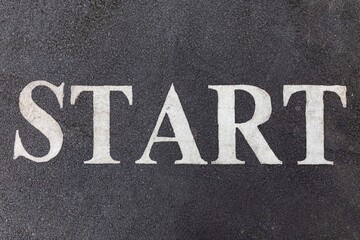 Start letters on an asphalt track texture and background