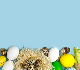 Easter colorful background with eggs in nest on blue background.