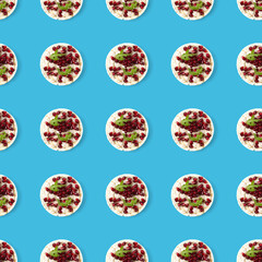 Seamless pattern from galettHealthy breakfast with rice cake and pomegranate on turquoise flat lay