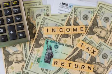 Fototapeta na wymiar Individual Income Tax return form 1040 U.S. with calculator on US american dollars