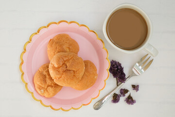Homemade choux cream or Choux Pastry or Profiterole or Eclair or cream puff on pink plate near  the dessert fork serve with tea or coffee. French dessert concept. selected focus.