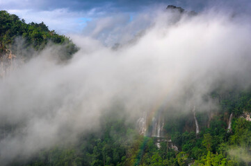 Fog and Rainbow in front of Thi Lo Su Waterfall, Beautiful waterfall in deep forest, Umphang National Park, Tak Province, Thailand.