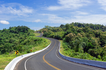 Fototapeta premium Road number 3 or the beautiful sky road above the mountain peak where tourists' motorcycles roaming the mountain in Nan Province, Thailand.
