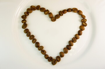 heart lined with coffee beans. coffee heart on a white background. I like coffe. background for Valentines Day - heart made of coffee beans