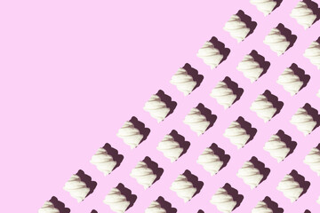 Pattern of air white marshmallows on a pink background copy space greeting cute card