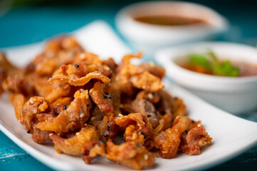 Crispy fried sliced belly pork with spicy sauce