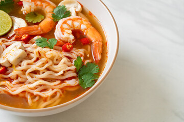 instant noodles ramen in spicy soup with shrimps (Tom Yum Kung)