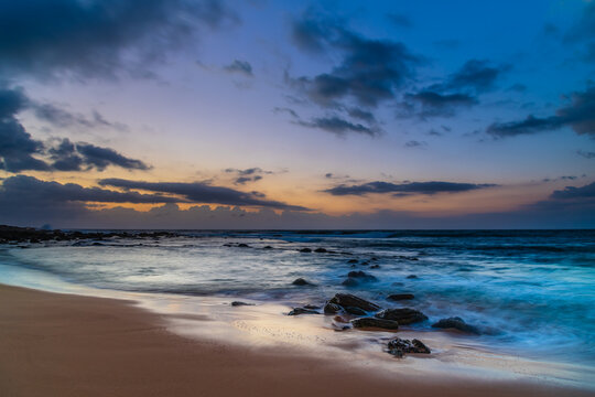Sunrise at the seaside with rain clouds rolling in
