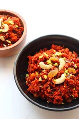 Gajar Halwa. Indian carrot pudding. It's a sweet dessert made from carrots, sugar, and cream. Garnished with cashew, almond, Raisin, and pistachio.