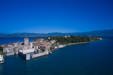 Aerial view on Sirmione sul Garda. Italy, Lombardy. View by Drone. Rocca Scaligera Castle in Sirmione. An ancient village on southern Garda Lake.