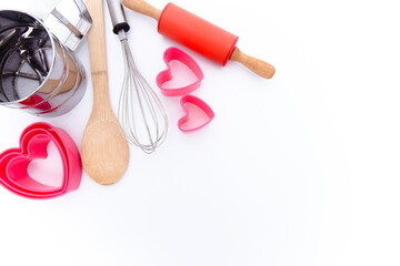 Baking background. Baking tools, whisk, spatula, rolling pin, heart molds