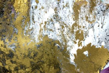 Golden dust background on white paint background. Sparkling gold texture.