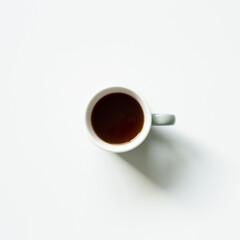 Cup of coffee on white background. top view, copy space