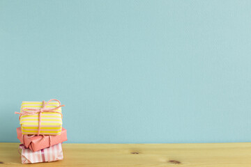 Colorful gift boxes on wooden table. sky blue background