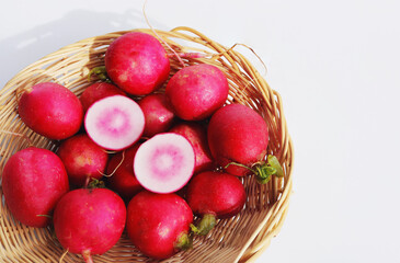 Radishes on white background. Whole and sliced radishes close up.
