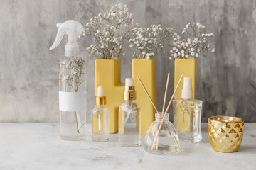 Natural air freshener and essential oil on grey background