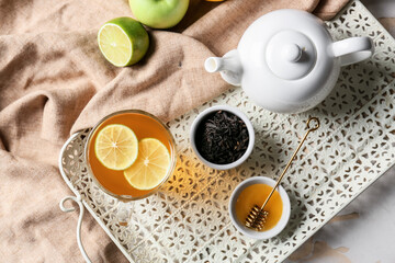 Composition with cup of hot healthy tea on light background