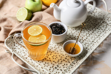 Composition with cup of hot healthy tea on light background