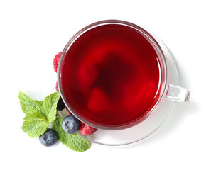 Cup of hot tea with berries on white background